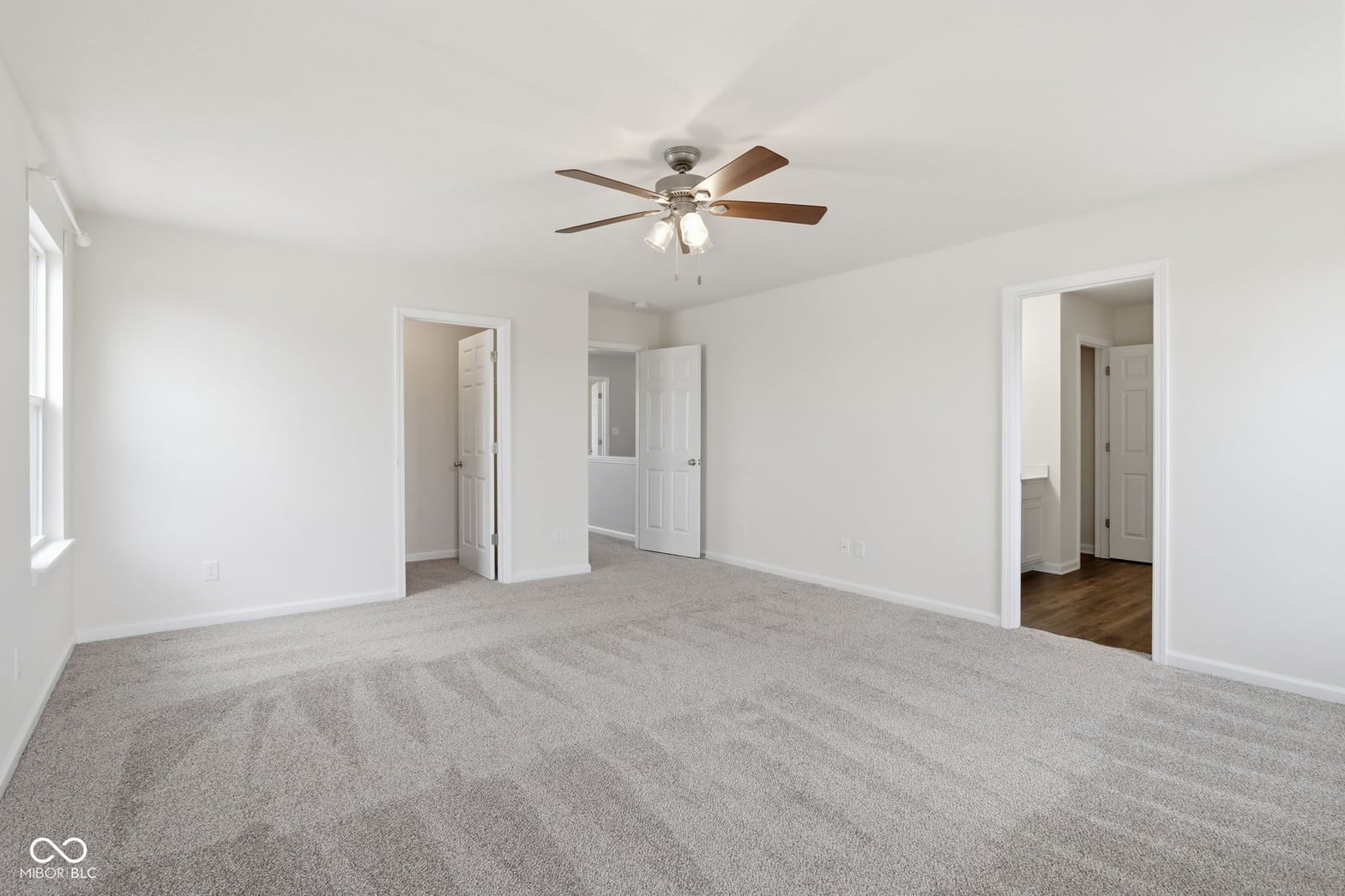 Spacious primary bedroom with ensuite access and abundant storage.