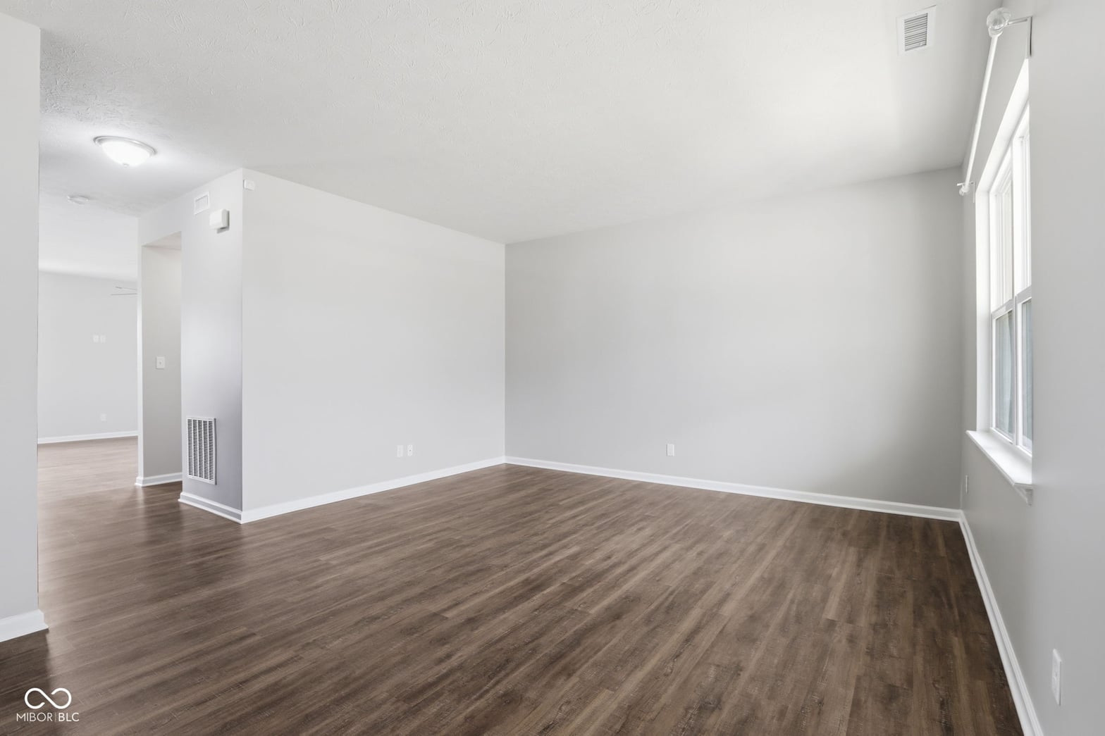 Bright, open living space with beautiful hardwood floors.