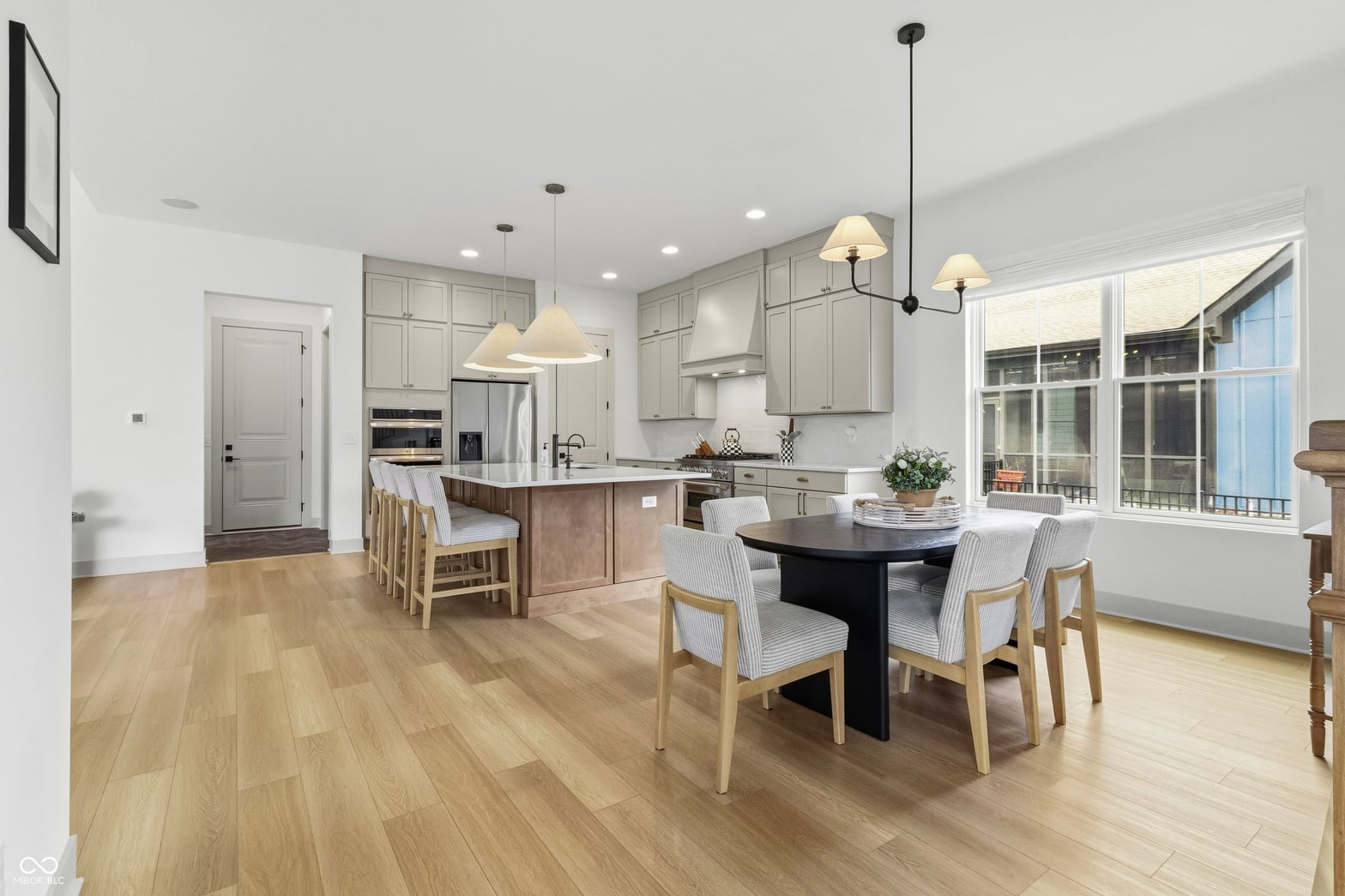 Bright open kitchen with island and expansive windows.