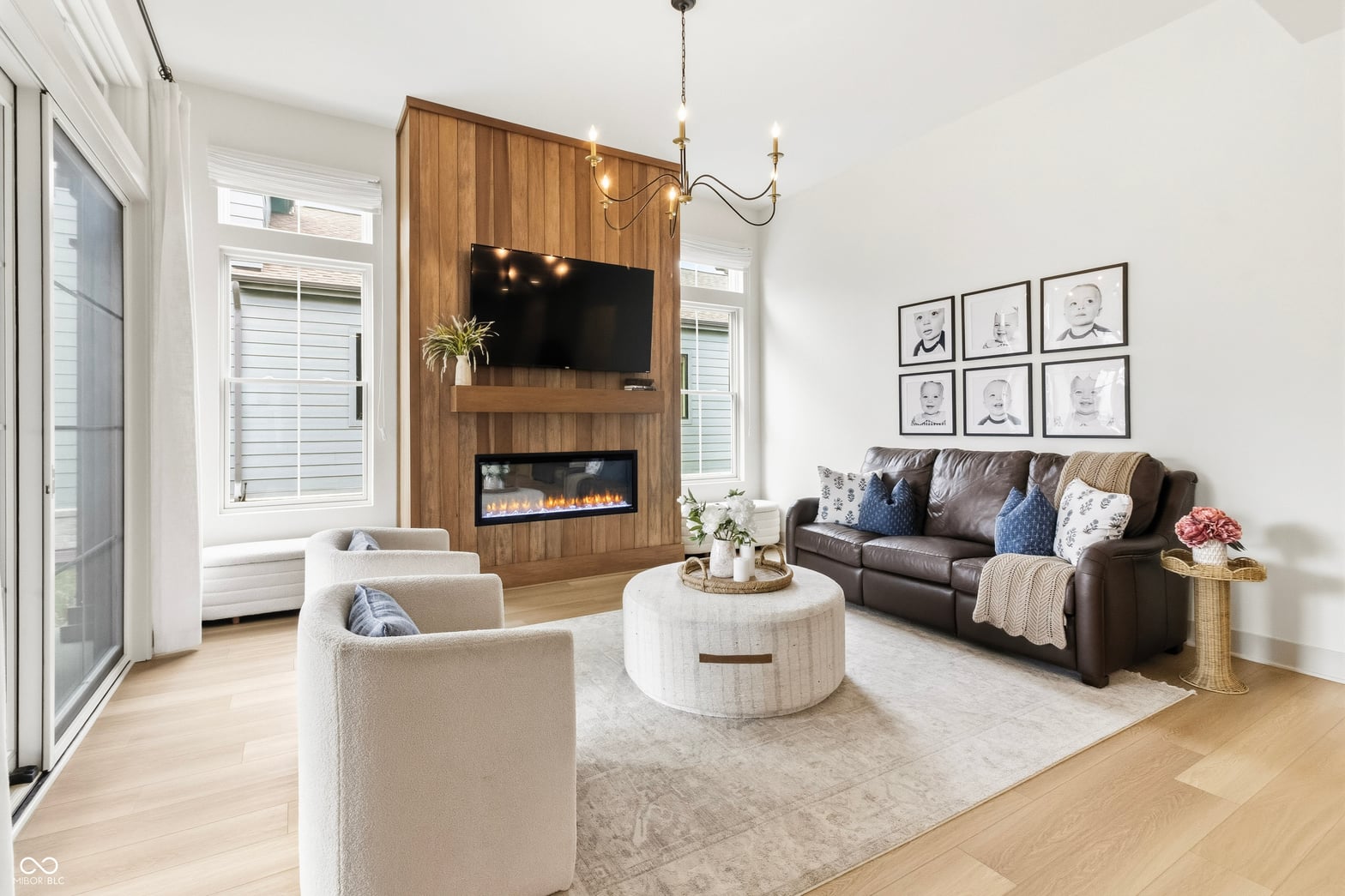 Stunning living room with electric fireplace and wood accent wall.