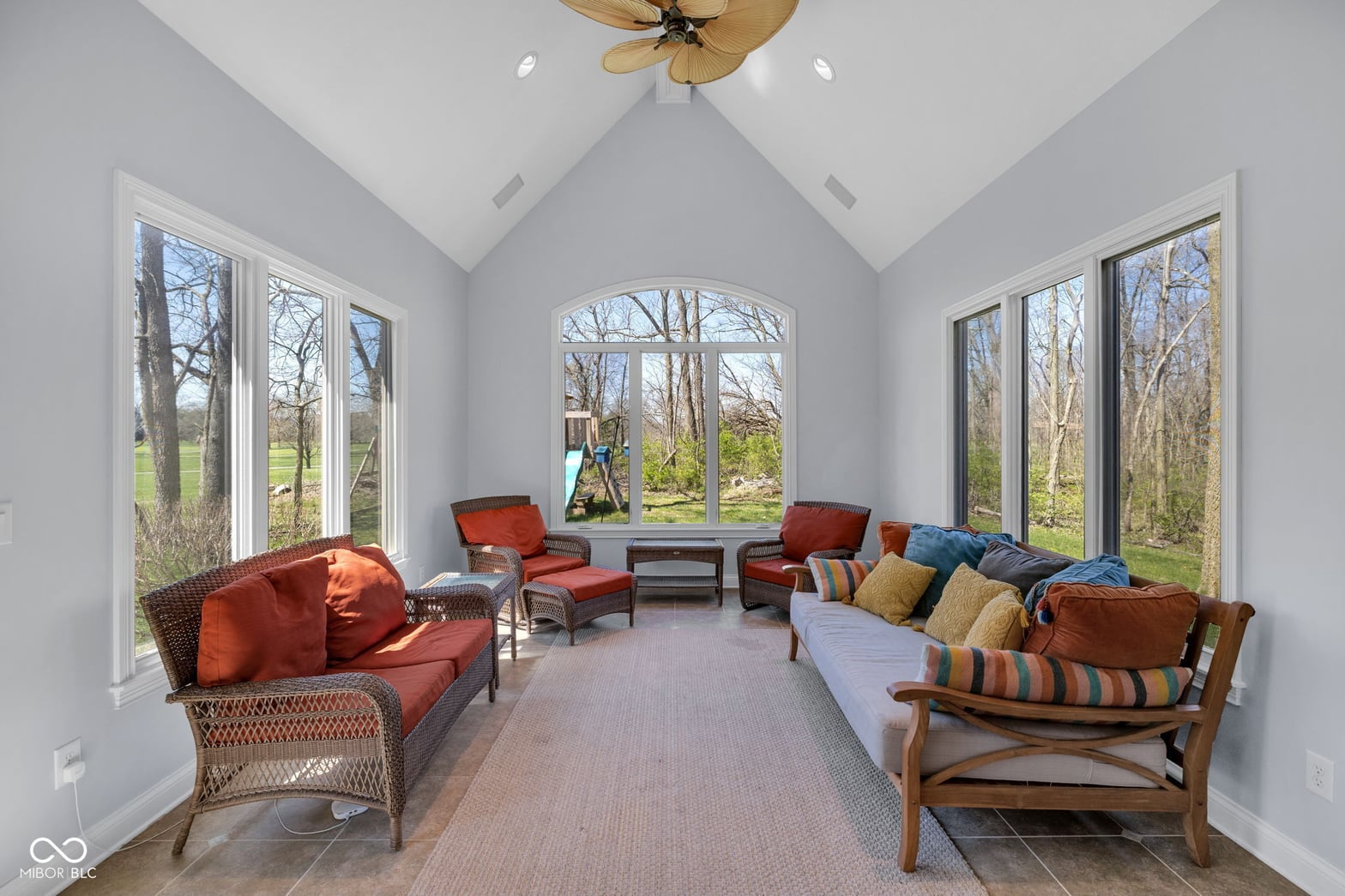 Bright renovated sunroom with vaulted ceilings and expansive views.