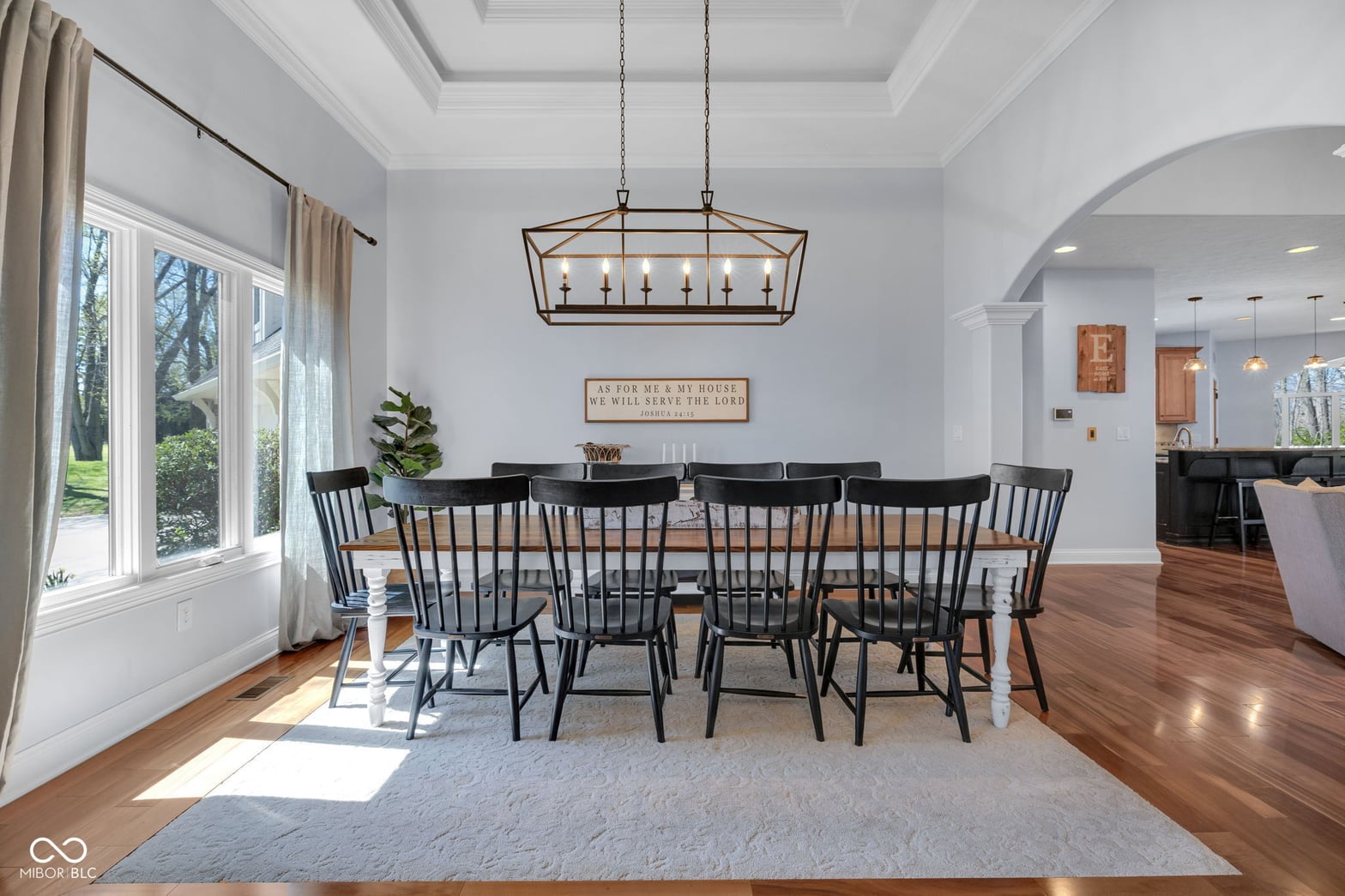 Bright dining room with coffered ceiling and abundant natural light.