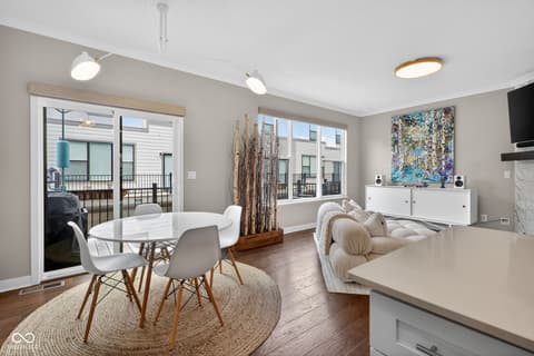 Family room at 11571 Huffington Street, Carmel, IN — Bright, modern open-concept space with expansive windows.