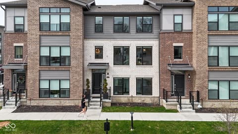 Front exterior at 11571 Huffington Street, Carmel, IN — Modern townhome with clean lines and premium finishes.