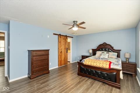 Primary bedroom at 10270 Apple Blossom Circle, Fishers, IN — Spacious primary bedroom with barn door and ensuite access.