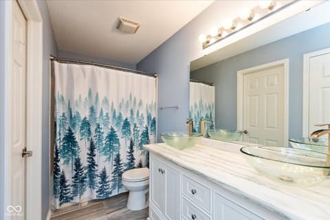Primary bathroom at 10270 Apple Blossom Circle, Fishers, IN — Spa-like primary bath with dual vanity and marble counters.