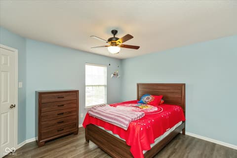 Bedroom at 10270 Apple Blossom Circle, Fishers, IN — Bright bedroom with natural light and wood furnishings.