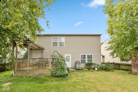 Backyard at 10270 Apple Blossom Circle, Fishers, IN — Spacious backyard with mature trees and deck.