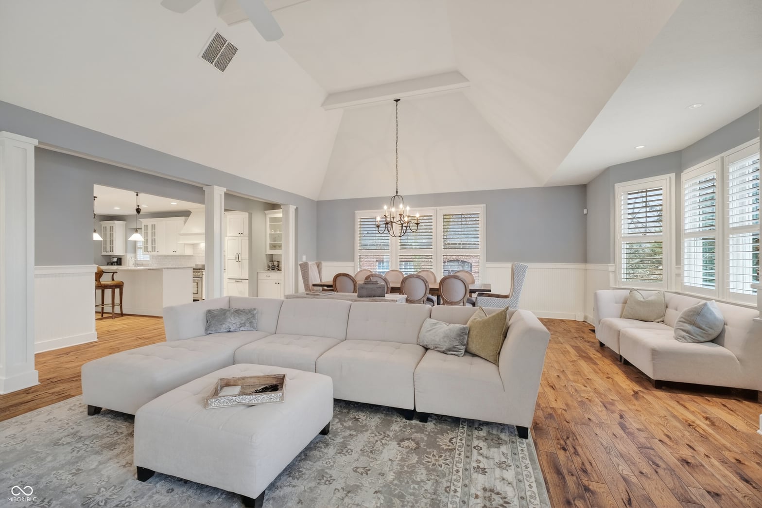 Bright open living space with vaulted ceilings and elegant finishes.