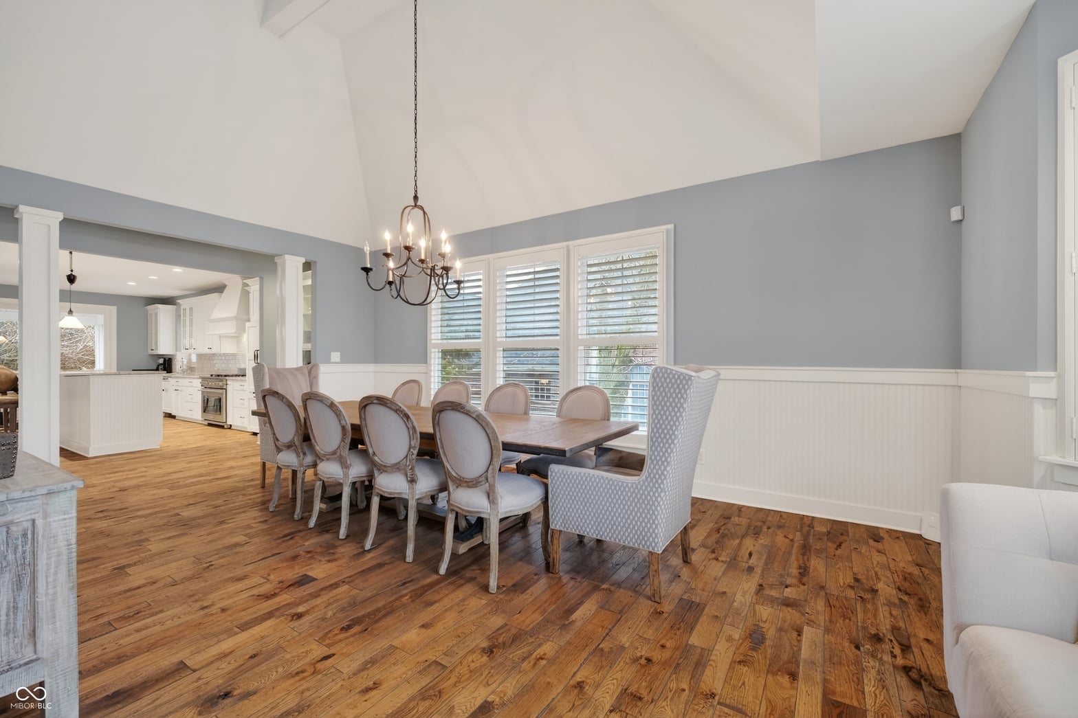 Elegant dining room with vaulted ceilings and hardwood floors.