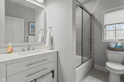 Primary bathroom at 96 Cedar Lane, Cicero, IN — Spa-like primary bath with frameless shower and dual vanity.