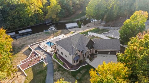 Aerial view at 96 Cedar Lane, Cicero, IN — Elegant home with pool and mature landscaping on wooded lot.