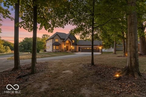 Front exterior at 96 Cedar Lane, Cicero, IN — New construction estate nestled among towering mature trees.