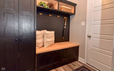 Foyer at 6583 Apperson Drive, Noblesville, IN — Custom mudroom with built-in storage and lighting.