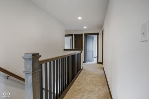 Hallway at 18808 Cromarty Circle, Noblesville, IN — Bright contemporary hallway with modern stair railing.