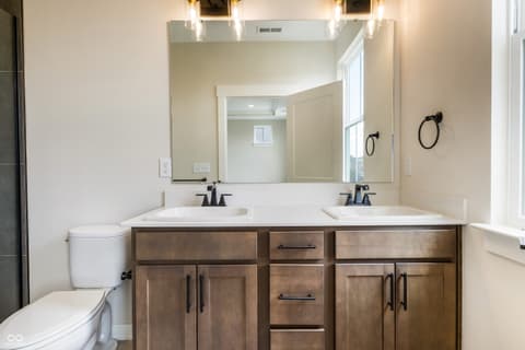 Primary bathroom at 18802 Cromarty Circle, Noblesville, IN — Luxurious primary bath with dual vanity and quartz surfaces.