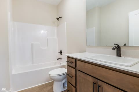 Primary bathroom at 18802 Cromarty Circle, Noblesville, IN — Spacious primary bath with wood vanity and modern fixtures.