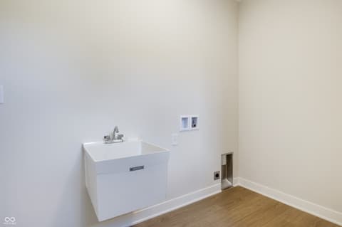 Laundry room at 18802 Cromarty Circle, Noblesville, IN — Modern utility room with sleek white sink cabinetry.