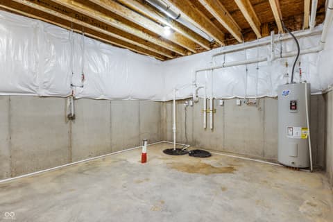 Basement at 18802 Cromarty Circle, Noblesville, IN — Unfinished basement with exposed beams and utility systems.