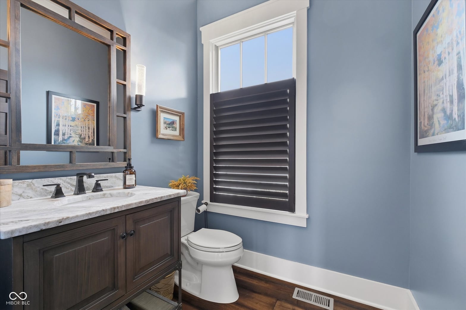 Elegant primary bath with marble counters and quality finishes.