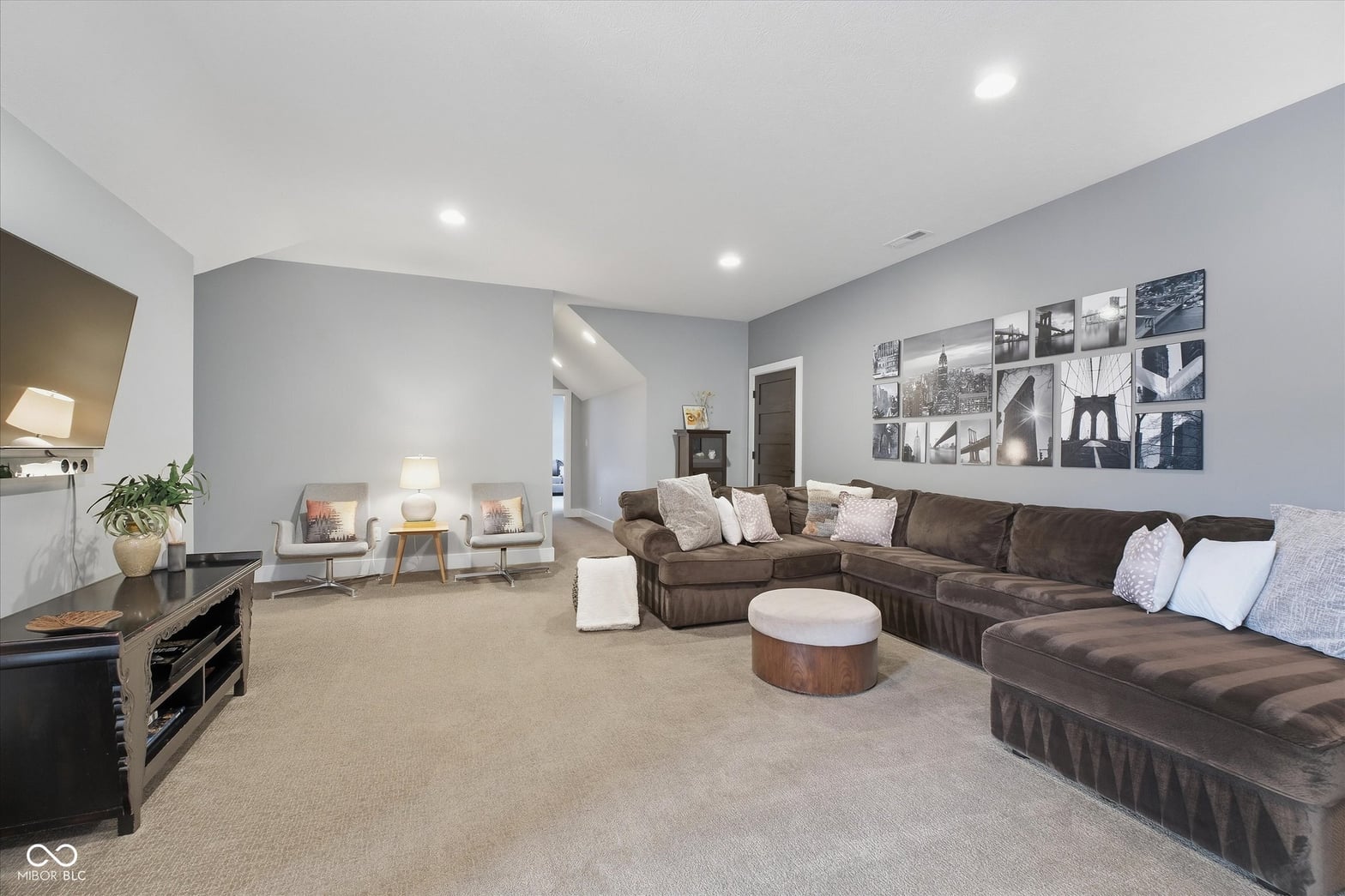 Spacious family room with modern finishes and abundant seating.