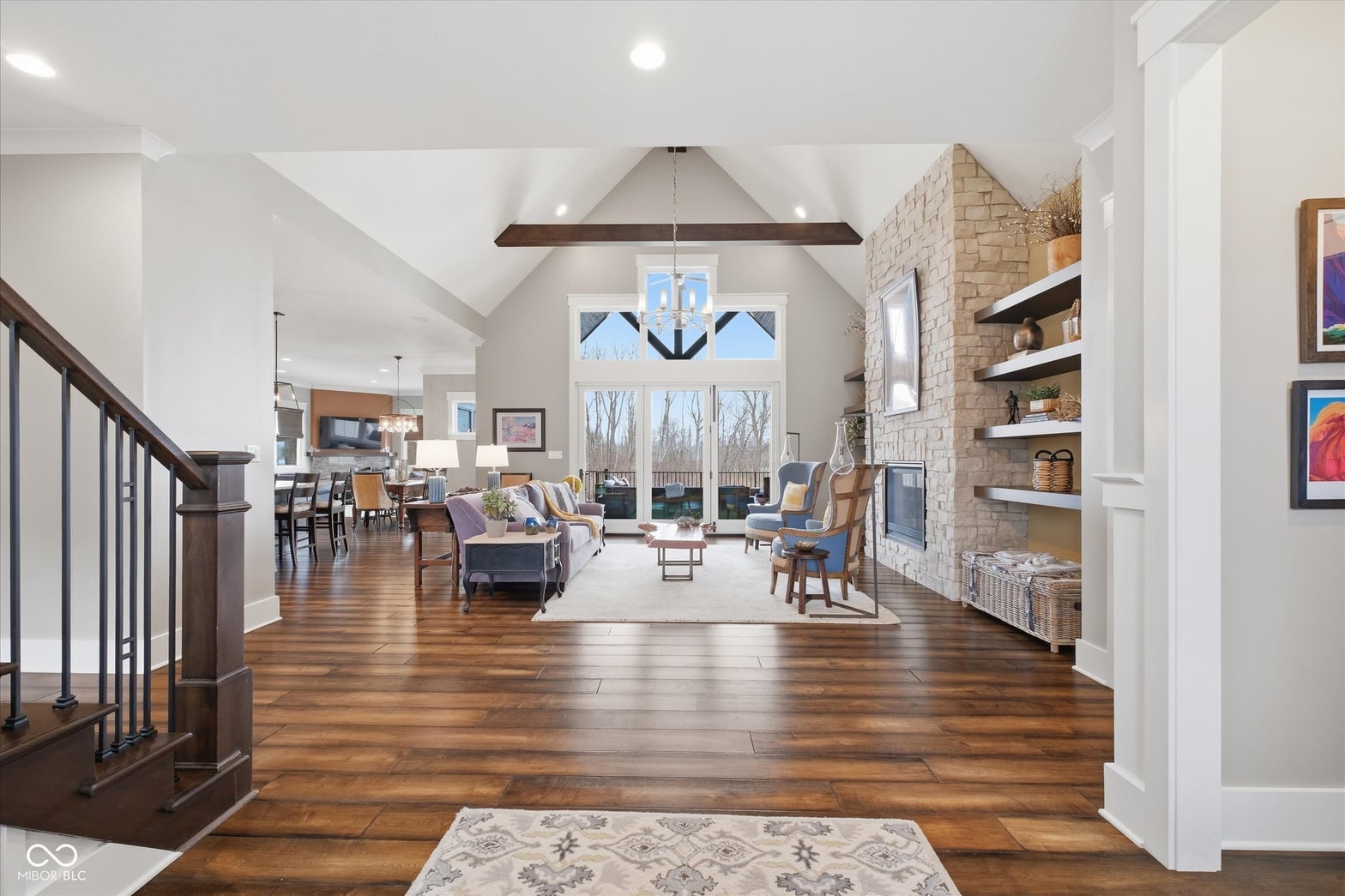 Bright open living space with fireplace and natural light.