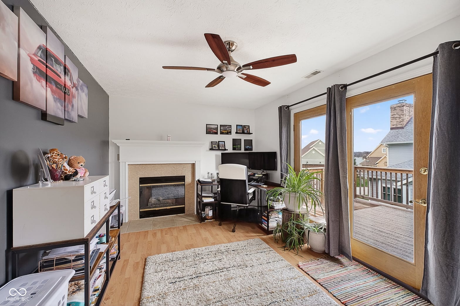Open family room with fireplace and deck access.
