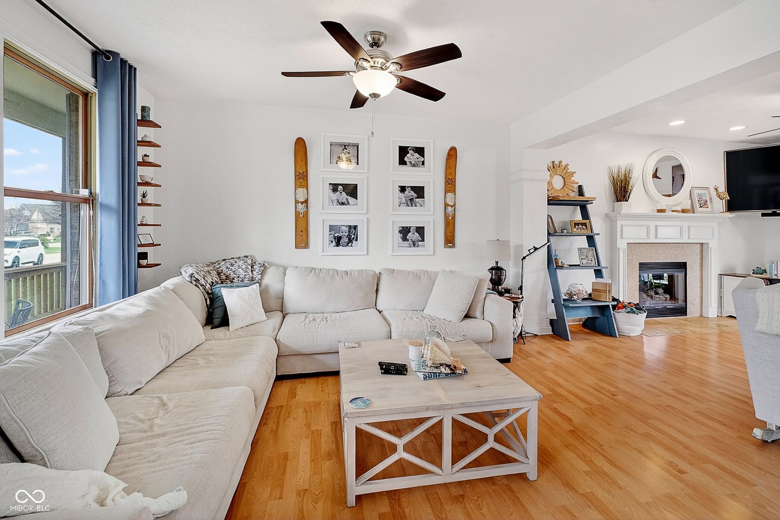 Bright living room with hardwood floors and fireplace.
