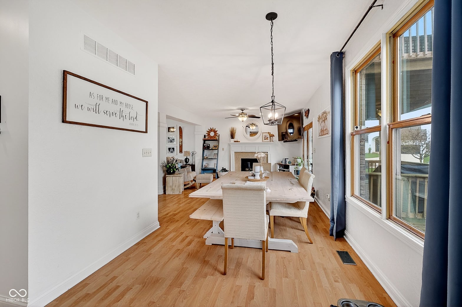 Bright open dining area with fireplace and abundant natural light.