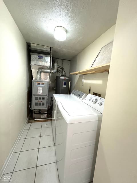 Laundry room at 12423 Ensley Place, Fishers, IN — Functional laundry room with utilities and appliances.