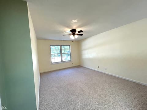 Bedroom at 12423 Ensley Place, Fishers, IN — Bright bedroom with natural light and ceiling fan.
