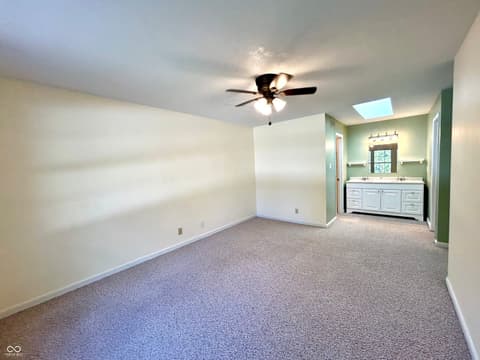 Primary bedroom at 12423 Ensley Place, Fishers, IN — Bright primary suite with ensuite bath and skylight.