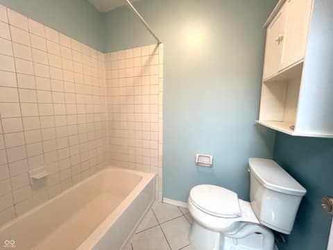 Bathroom at 12423 Ensley Place, Fishers, IN — Functional bathroom with tub-shower combo and storage.