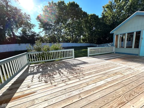Outdoor living area at 12423 Ensley Place, Fishers, IN — Spacious waterfront deck with updated composite flooring.