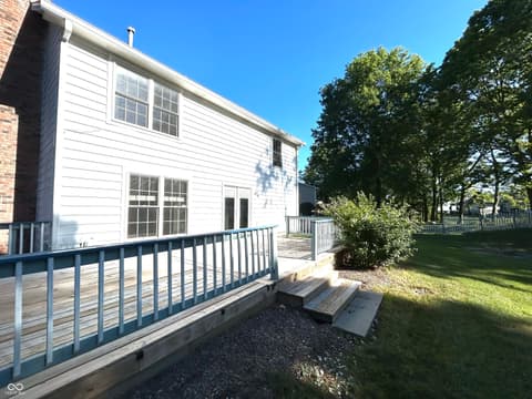 Backyard at 12423 Ensley Place, Fishers, IN — Renovated home with modern deck and mature landscaping.