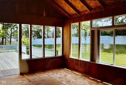 Outdoor living area at 12423 Ensley Place, Fishers, IN — Bright sunroom with expansive windows overlooking yard.