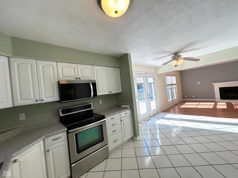 Kitchen at 12423 Ensley Place, Fishers, IN — Spacious updated kitchen with open concept living area.