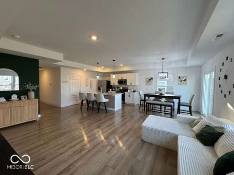Living room at 876 Garrow Drive, Westfield, IN — Spacious open-concept living with gleaming hardwood floors.