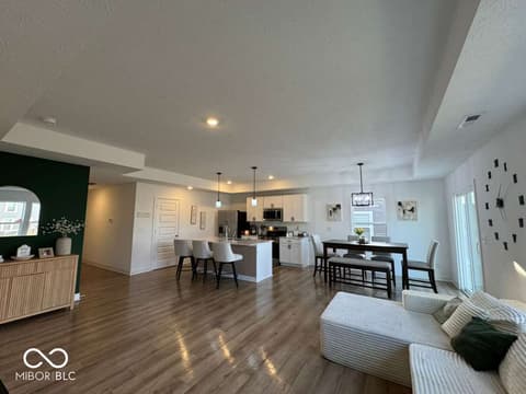 Living room at 876 Garrow Drive, Westfield, IN — Open-concept living with modern kitchen and hardwood floors.