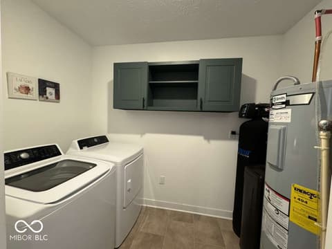 Laundry room at 876 Garrow Drive, Westfield, IN — Modern laundry room with full appliances and storage.