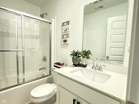 Primary bathroom at 876 Garrow Drive, Westfield, IN — Bright modern bathroom with luxe quartz finishes.