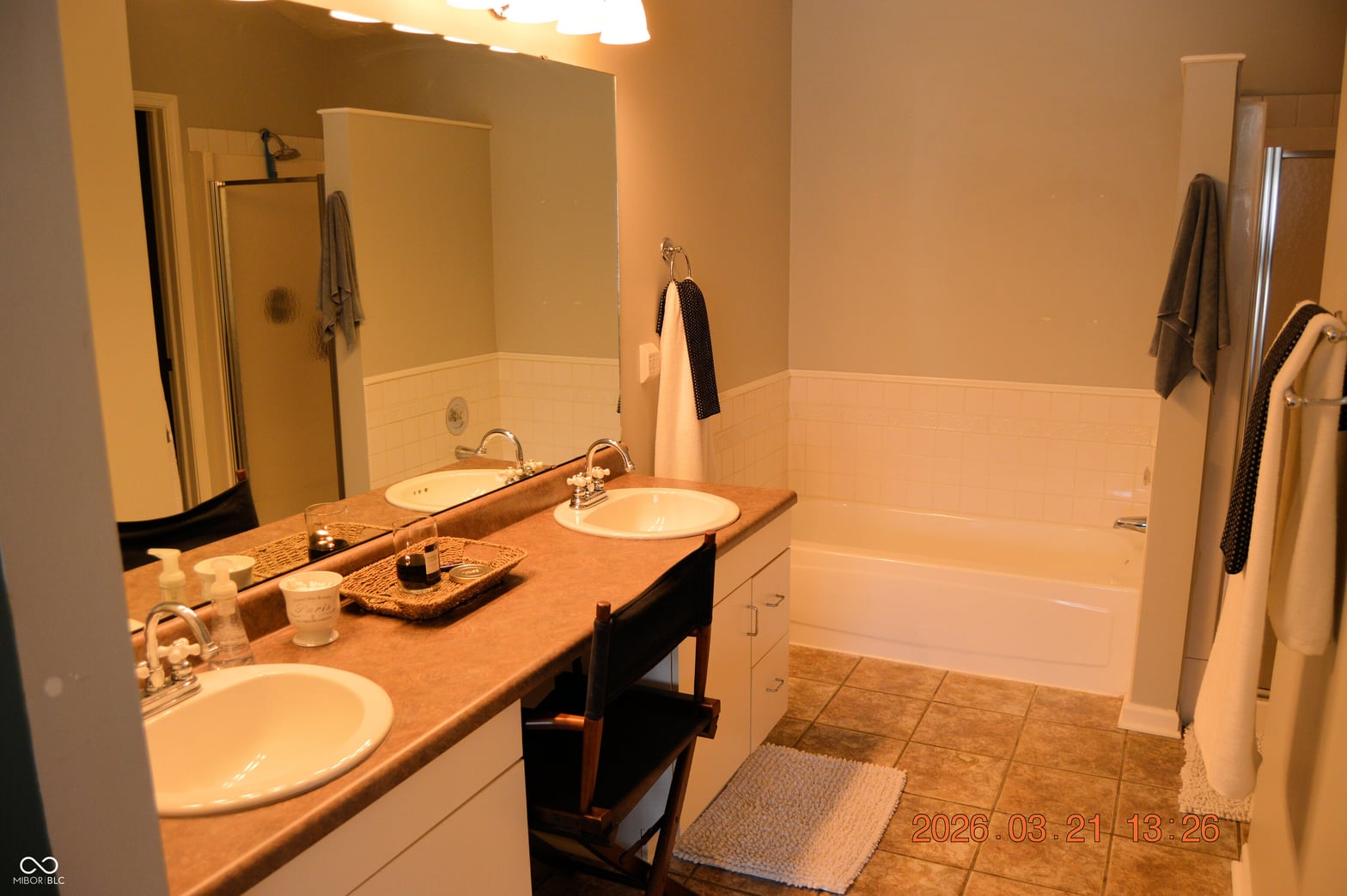 Spacious primary bath with dual vanity and soaking tub.
