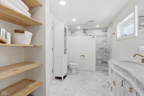 Primary bathroom at 1607 Cherry Street, Noblesville, IN — Spa-like primary bath with marble and modern finishes.