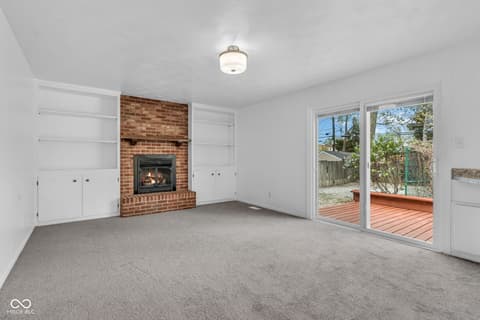 Family room at 18 Wilson Drive, Carmel, IN — Spacious family room with fireplace and backyard access.