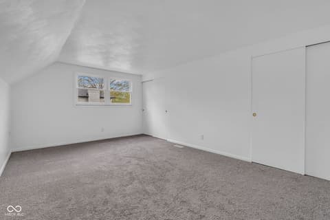 Bonus room at 18 Wilson Drive, Carmel, IN — Bright bonus room with vaulted ceiling and ample storage.