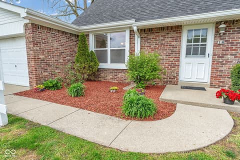 Front exterior at 18 Wilson Drive, Carmel, IN — Well-maintained brick ranch with landscaped curb appeal.