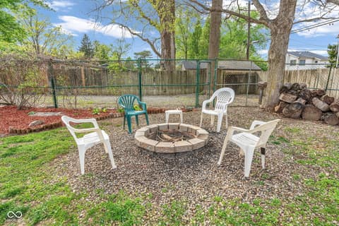 Yard at 18 Wilson Drive, Carmel, IN — Spacious backyard with fire pit and mature trees