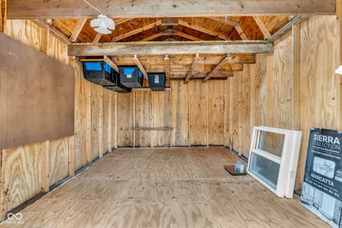 Garage at 18 Wilson Drive, Carmel, IN — Spacious garage with exposed beams and vaulted ceiling.