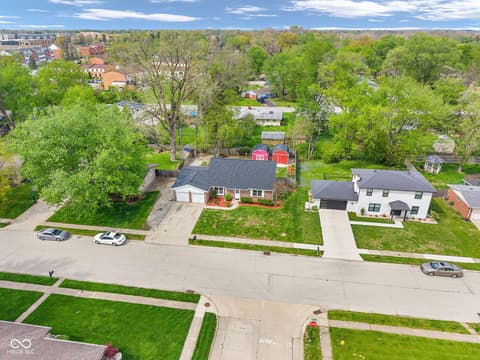 Aerial view at 18 Wilson Drive, Carmel, IN — Well-maintained brick ranch with mature landscaping.