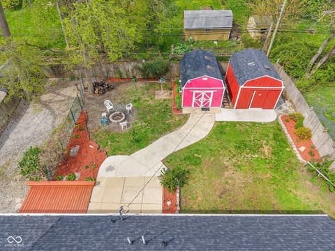Aerial view at 18 Wilson Drive, Carmel, IN — Charming property with functional barns and lush grounds.